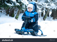 stock-photo-little-boy-riding-snowmobile-in-forest-95701183.jpg
