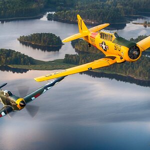 Finnish_Air_Force_Hawker_Hurricane_warbird_and_US_Navy_T-6_Texan_warbird_in_flight_over_Finland.jpg